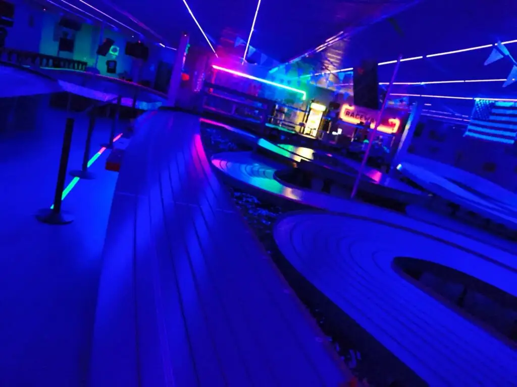 A slot car track under black light at Lanes Raceway